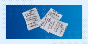 3 desiccant packets on a blue background